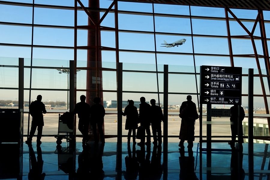 travelers silhouettes at airport